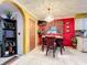 Dining area with red walls and a chandelier, open to the kitchen at 316 Amanda Ln, Leesburg, FL 34748
