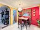 Bright dining area with a red accent wall and a chandelier at 316 Amanda Ln, Leesburg, FL 34748