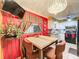 Dining area with a red accent wall and a chandelier, next to the kitchen at 316 Amanda Ln, Leesburg, FL 34748