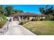 House exterior showcasing a well-maintained lawn and a decorative garage door at 316 Amanda Ln, Leesburg, FL 34748