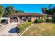 Ranch style home with landscaped yard, decorative fountain, and a circular driveway at 316 Amanda Ln, Leesburg, FL 34748