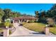 Ranch style home with circular driveway, landscaped lawn, and decorative fountain at 316 Amanda Ln, Leesburg, FL 34748