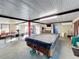 Game room features a pool table, seating area, and dining table at 316 Amanda Ln, Leesburg, FL 34748