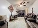Gathering room includes comfortable seating, a home office setup, and a large TV at 316 Amanda Ln, Leesburg, FL 34748
