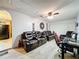 Spacious Gathering room featuring comfortable leather seating and a home office area at 316 Amanda Ln, Leesburg, FL 34748