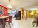 Kitchen and dining area, with a black refrigerator and light colored cabinets at 316 Amanda Ln, Leesburg, FL 34748