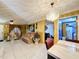 Bright living room with tiled floors, comfy seating, and a decorative chandelier at 316 Amanda Ln, Leesburg, FL 34748