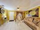 Bright living room with tiled floors, beige sofas, and decorative wall art at 316 Amanda Ln, Leesburg, FL 34748