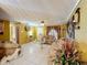 Living room featuring tiled floors, a neutral colored couch, and decorative accents at 316 Amanda Ln, Leesburg, FL 34748