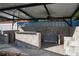 Covered patio with outdoor kitchen and ceiling fans at 316 Amanda Ln, Leesburg, FL 34748
