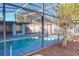 Inviting screened pool area with surrounding landscaping at 316 Amanda Ln, Leesburg, FL 34748