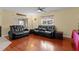 Living area features hardwood floors and black leather recliners at 324 Tomato Hill Rd, Leesburg, FL 34748