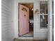 Inviting entryway with a pink door and tiled flooring at 32619 Oak Park Dr, Leesburg, FL 34748