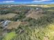Aerial view of property showing surrounding land and lake at 4235 Dove Valley Ln, Lady Lake, FL 32159