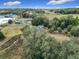 Rural property with a damaged structure and lake in the distance at 4235 Dove Valley Ln, Lady Lake, FL 32159