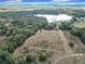 Aerial view showcasing a large parcel of land near a lake, offering a tranquil setting at 4235 Dove Valley Ln, Lady Lake, FL 32159