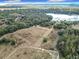 Aerial view showcasing a large parcel of land near a lake, offering a tranquil setting at 4235 Dove Valley Ln, Lady Lake, FL 32159