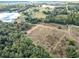 Aerial view showcasing a large parcel of land near a lake, offering a tranquil setting at 4235 Dove Valley Ln, Lady Lake, FL 32159