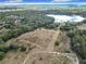 Aerial view showcasing a large parcel of land near a lake, offering a tranquil setting at 4235 Dove Valley Ln, Lady Lake, FL 32159