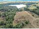 Aerial view showcasing a large parcel of land near a lake, offering a tranquil setting at 4235 Dove Valley Ln, Lady Lake, FL 32159