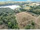 Aerial view showcasing a large parcel of land near a lake, offering a tranquil setting at 4235 Dove Valley Ln, Lady Lake, FL 32159