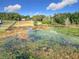 Lake view with abundant lily pads and vegetation at 4235 Dove Valley Ln, Lady Lake, FL 32159