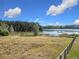 Lakefront land with a partially visible wooden fence at 4235 Dove Valley Ln, Lady Lake, FL 32159