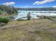 Overgrown land with a lake view and wooden fence at 4235 Dove Valley Ln, Lady Lake, FL 32159