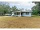 Light blue house with a screened porch and yard at 4796 Cr 688, Webster, FL 33597