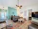 Living room with leather furniture, area rug, and ceiling fan at 4800 Tara View Rd, Leesburg, FL 34748