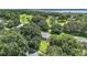Aerial view of single-story home on a large lot with golf course and water views at 6147 Spinnaker Loop, Lady Lake, FL 32159