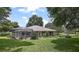 Landscaped backyard with a view of the home's exterior at 6147 Spinnaker Loop, Lady Lake, FL 32159