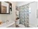 Small bathroom with a tub shower, and paisley shower curtain at 6147 Spinnaker Loop, Lady Lake, FL 32159
