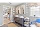 Double vanity bathroom with a view into a bedroom at 6147 Spinnaker Loop, Lady Lake, FL 32159