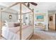 Spacious Primary bedroom with a large canopy bed and sitting area at 6147 Spinnaker Loop, Lady Lake, FL 32159