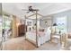Elegant bedroom with a canopy bed, and access to a patio at 6147 Spinnaker Loop, Lady Lake, FL 32159