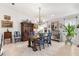 Elegant dining room featuring a large wooden table, blue chairs, and a unique chandelier at 6147 Spinnaker Loop, Lady Lake, FL 32159