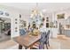 Bright dining area with a wooden table, blue chairs, and kitchen view at 6147 Spinnaker Loop, Lady Lake, FL 32159