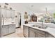 Updated kitchen with stainless steel appliances and gray cabinets at 6147 Spinnaker Loop, Lady Lake, FL 32159