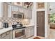 Modern kitchen with stainless steel appliances and gray cabinets at 6147 Spinnaker Loop, Lady Lake, FL 32159