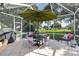 Peaceful screened patio with outdoor dining set and golf course view at 6147 Spinnaker Loop, Lady Lake, FL 32159