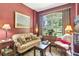 Elegant sitting room boasts a large window overlooking the backyard at 6147 Spinnaker Loop, Lady Lake, FL 32159
