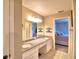 Double vanity bathroom with granite countertops and view of bedroom at 7991 Apple Blossom Dr, Lakeland, FL 33810