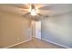 Well-lit bedroom with carpet and door to hallway at 7991 Apple Blossom Dr, Lakeland, FL 33810