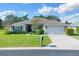 One-story home with a landscaped lawn, attached garage, and neutral exterior at 8 Diamond Club Rd, Ocala, FL 34472