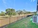 Backyard view with fence and distant golf course at 8512 Magnificent Ln, Groveland, FL 34736