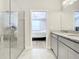 Spa-like bathroom with a walk-in shower and double vanity at 8512 Magnificent Ln, Groveland, FL 34736