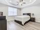 Bright bedroom with wood-look flooring and ceiling fan at 8512 Magnificent Ln, Groveland, FL 34736