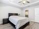 Cozy bedroom with wood-look floors and access to private bathroom at 8512 Magnificent Ln, Groveland, FL 34736