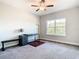 Bright bedroom with a desk, window, and ceiling fan at 8512 Magnificent Ln, Groveland, FL 34736